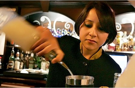 In this photo published by The New York Times, a confident Anushika Pradhan is seen tending bar at the Dublin Pub in the Maurya Sheraton Hotel in New Delhi, India.