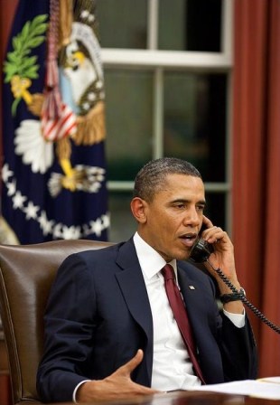 Obama talks on phone before making a statement about the mission against Osama.